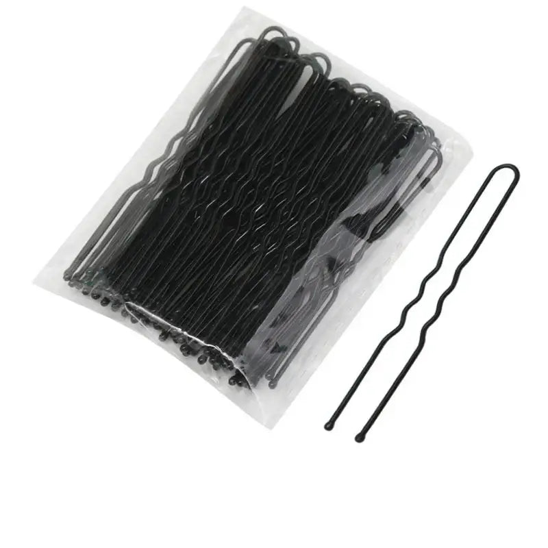 Black metal hair pins arranged in a clear plastic package.