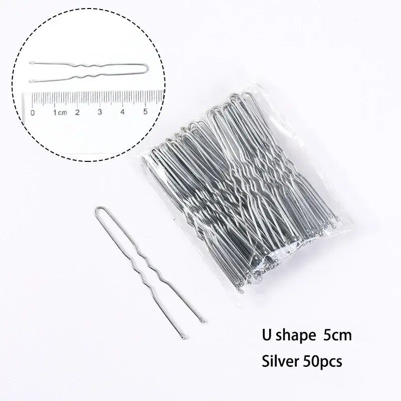 U-shaped silver hair pins packaged in a clear plastic bag.