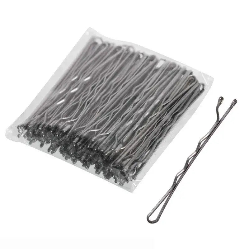 Bobby pins or hair pins arranged in rows inside clear packaging.