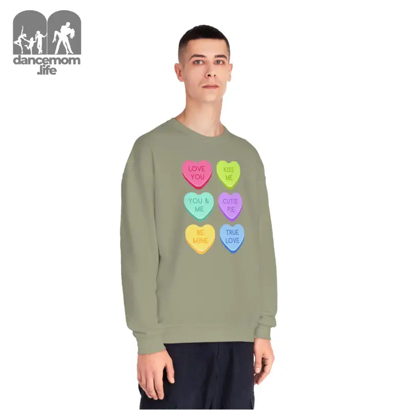 Sage green sweatshirt featuring colorful candy heart designs with text messages.