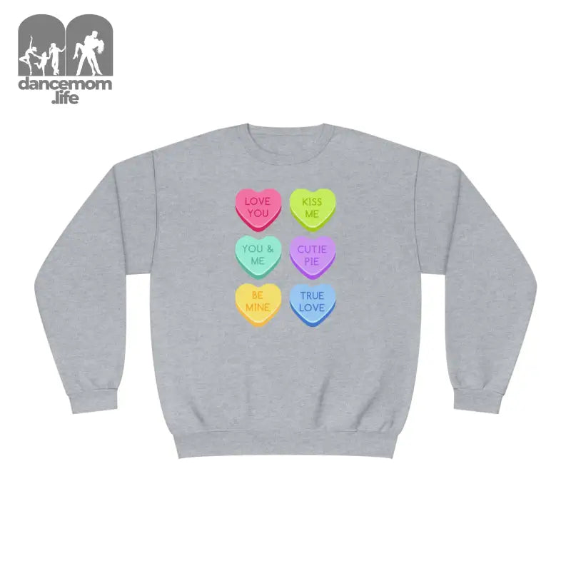 Grey sweatshirt with colorful candy heart designs printed on the front.