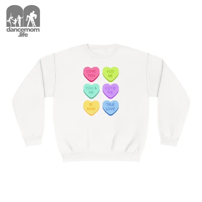 White sweatshirt featuring six colorful heart-shaped candy designs arranged in rows.