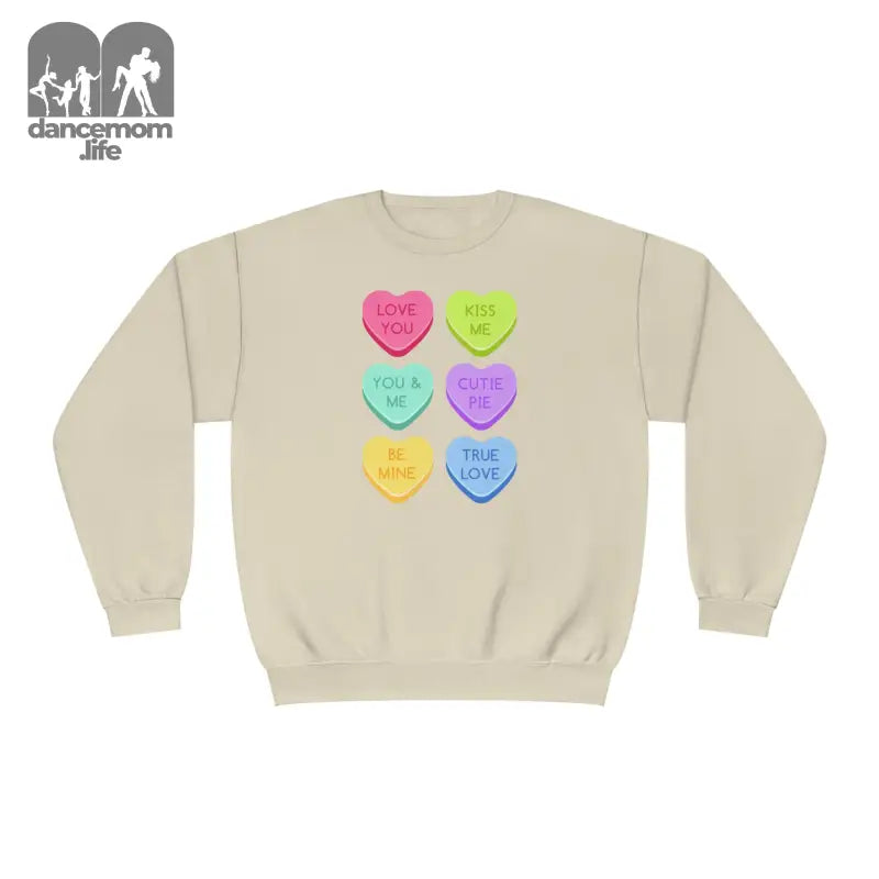 Beige sweatshirt with colorful candy heart designs printed on the front.