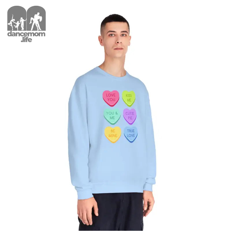 Light blue sweatshirt featuring colorful candy heart designs arranged in a grid pattern.