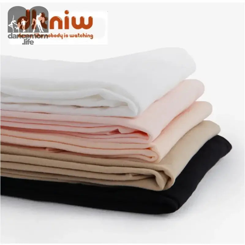 Stack of folded fabric pieces in white, pink, beige, and black colors.