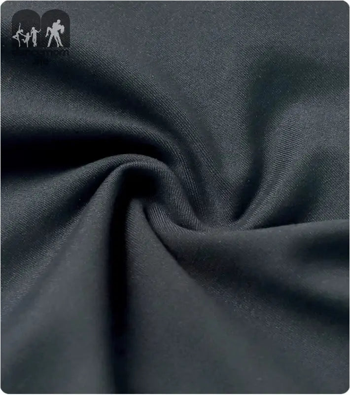 Dark grey fabric with soft, flowing folds and wrinkles.