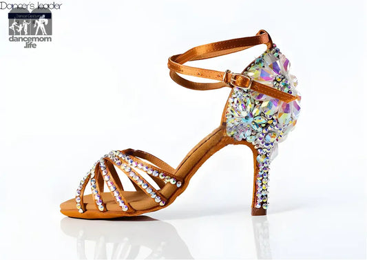 Rhinestone-studded tan dance shoe.