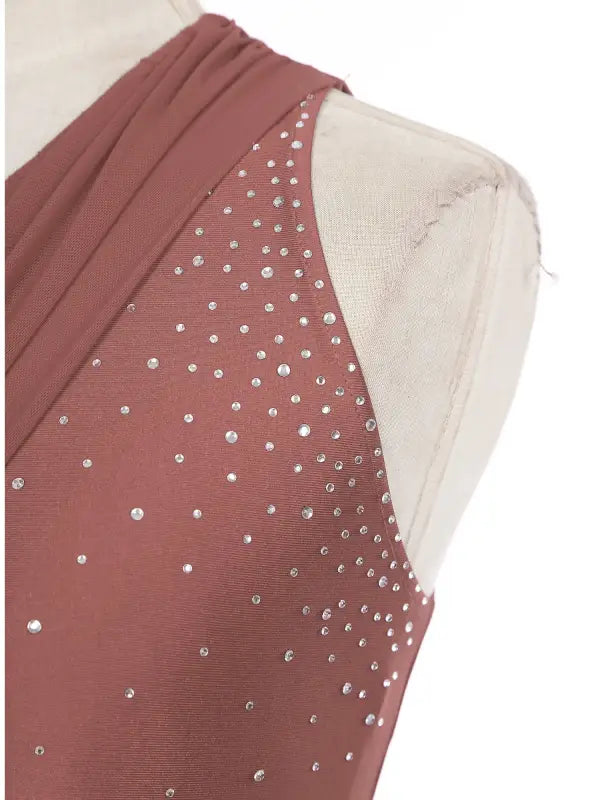 Dusty rose colored dress bodice with scattered rhinestone embellishments.