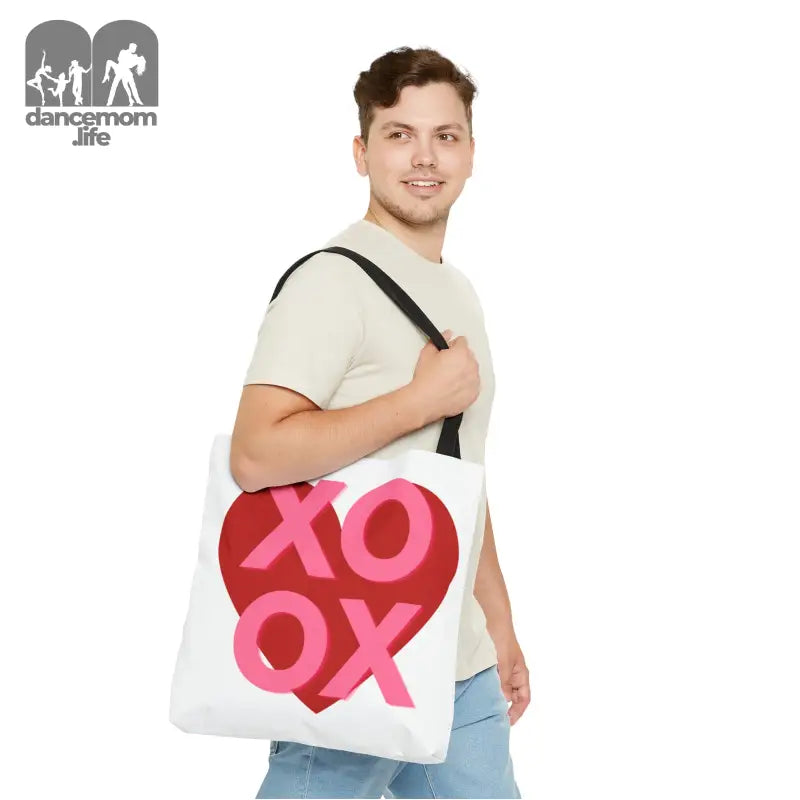 White tote bag with pink and red ’XOXO’ design.