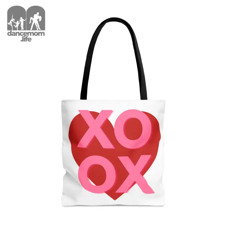 White tote bag with ’XOXO’ text in pink and red forming a heart shape.