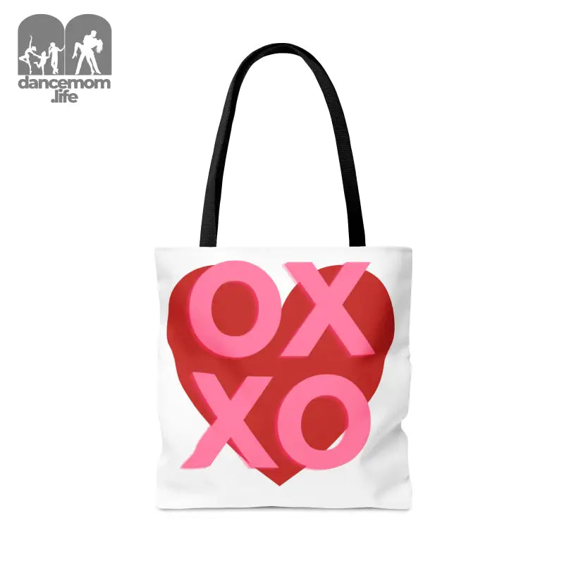 White tote bag with ’XOXO’ text inside a red heart design.